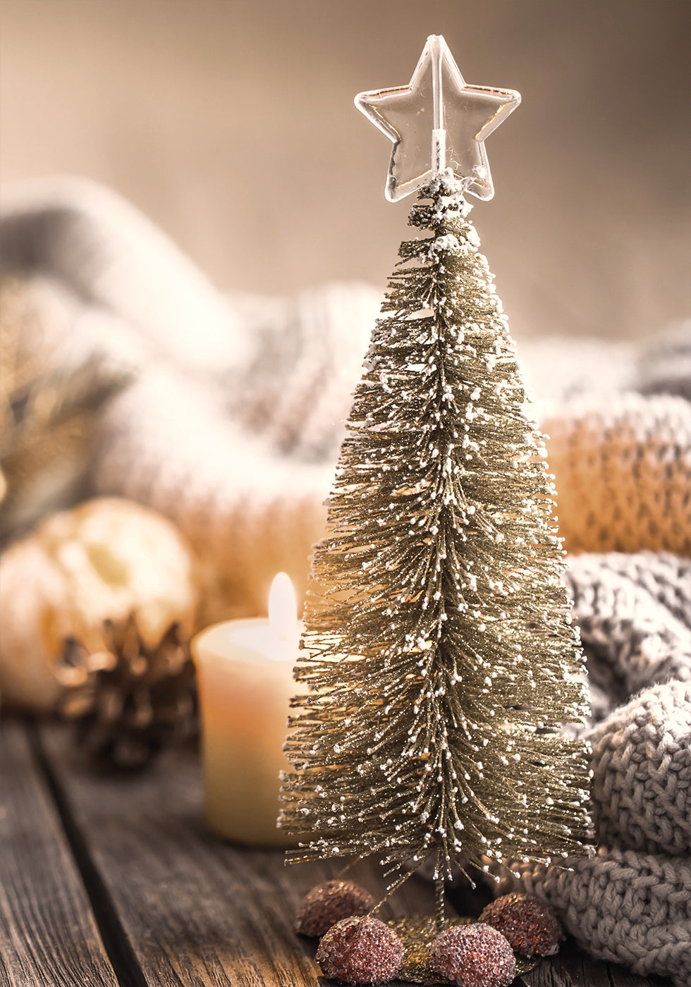 a small christmas tree sitting on top of a wooden table